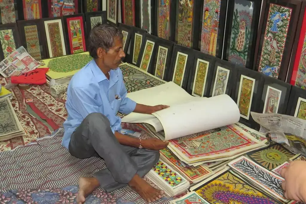 a seller showcasing madhubani art